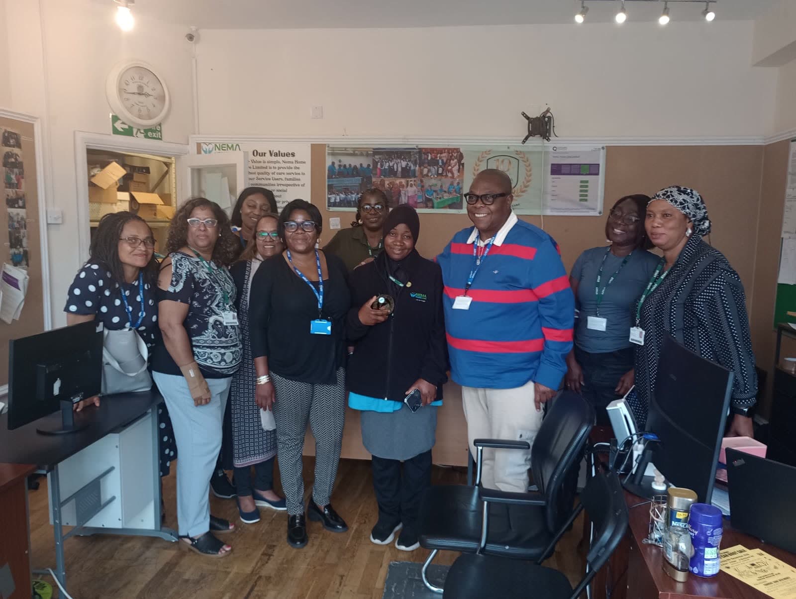 The Nema Home Care team standing together in their office